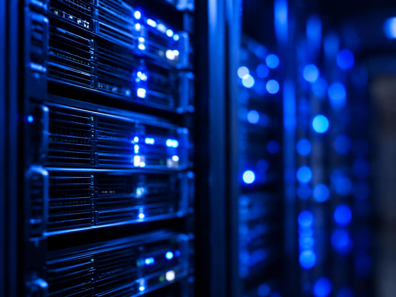 Server racks glowing with blue status lights in a data center